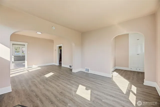 wooden floor in an empty room with a window
