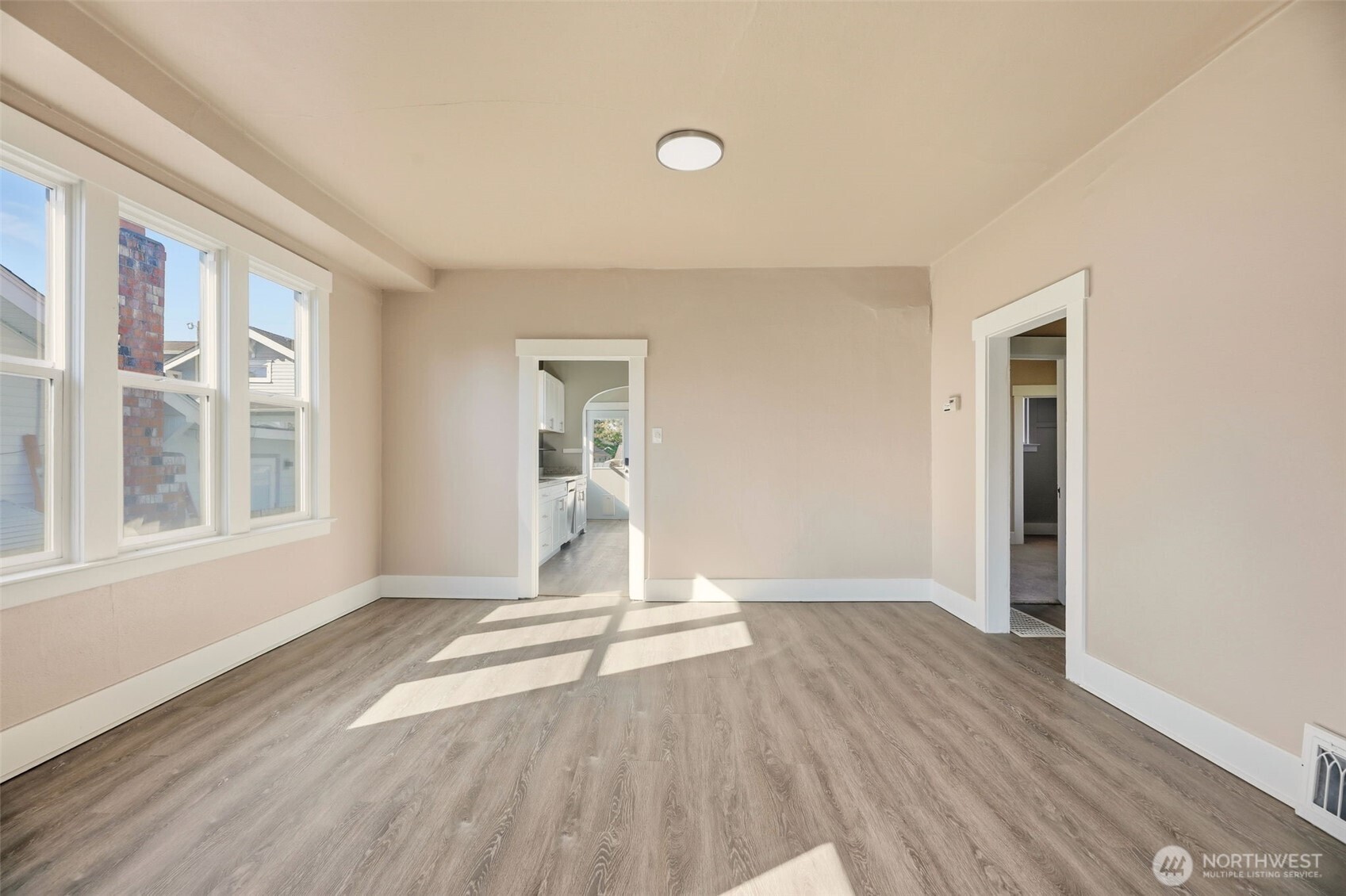 1726 Baker Avenue Everett, WA 98201 - Photo 15 of 39 a view of an empty room with wooden floor and a window
