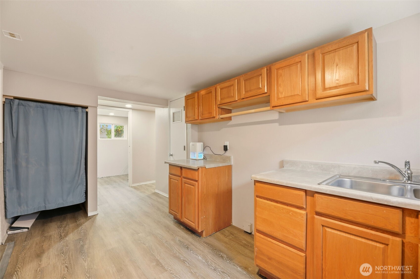 1726 Baker Avenue Everett, WA 98201 - Photo 26 of 39 a kitchen with stainless steel appliances granite countertop a sink and cabinets with wooden floor