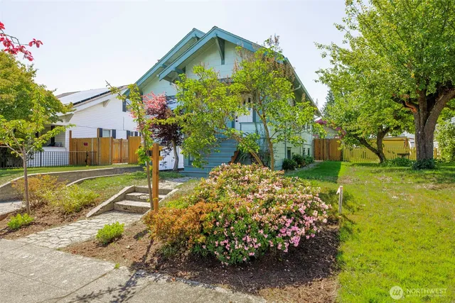 a view of a house with a wooden fence