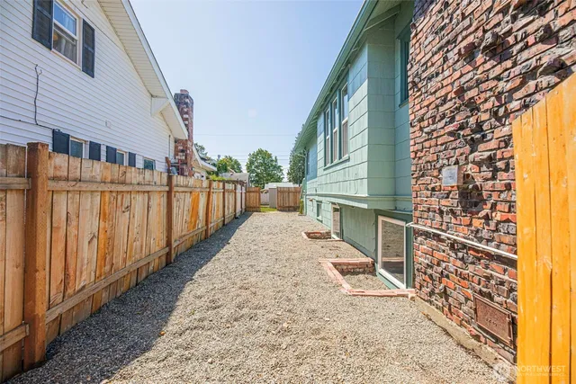 a view of a house with a wooden fence