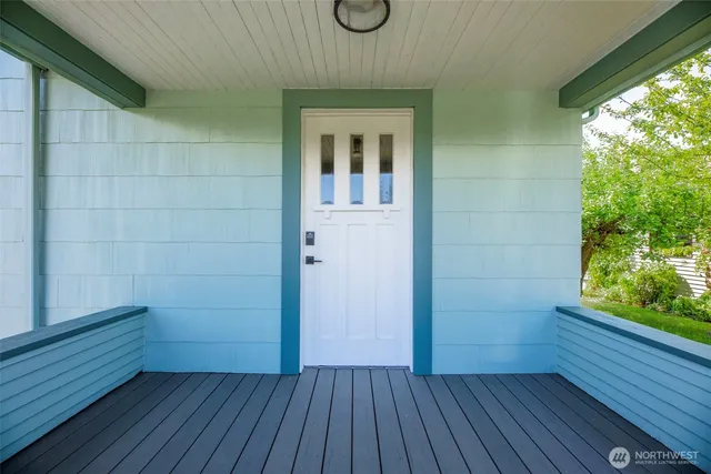 a view of a room with wooden floor and windows