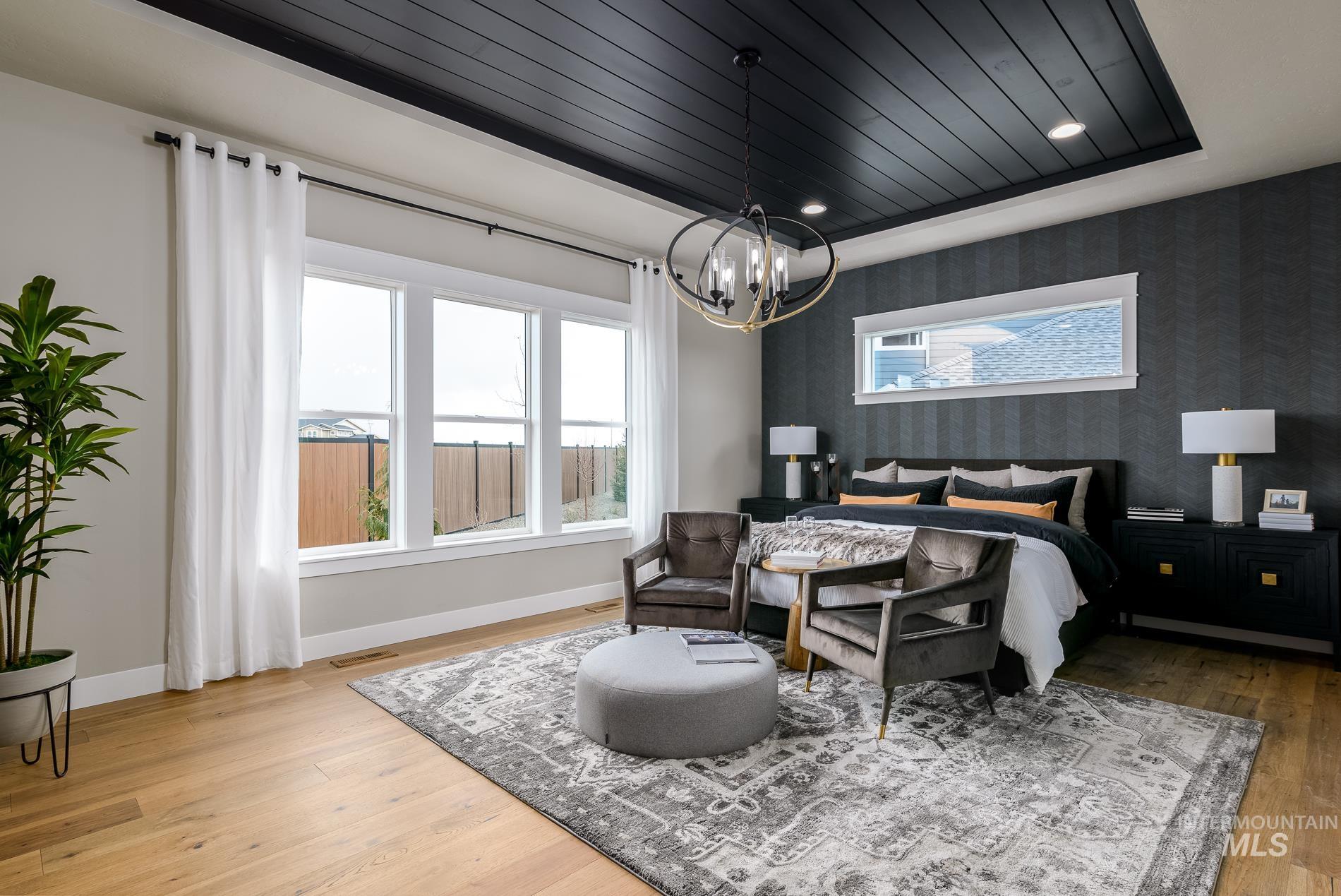 3370 North Del Sol Way Star, ID 83669 - Photo 10 of 30 Bedroom with wallpapered walls, multiple windows, light wood-type flooring, wood ceiling, and suspended lighting