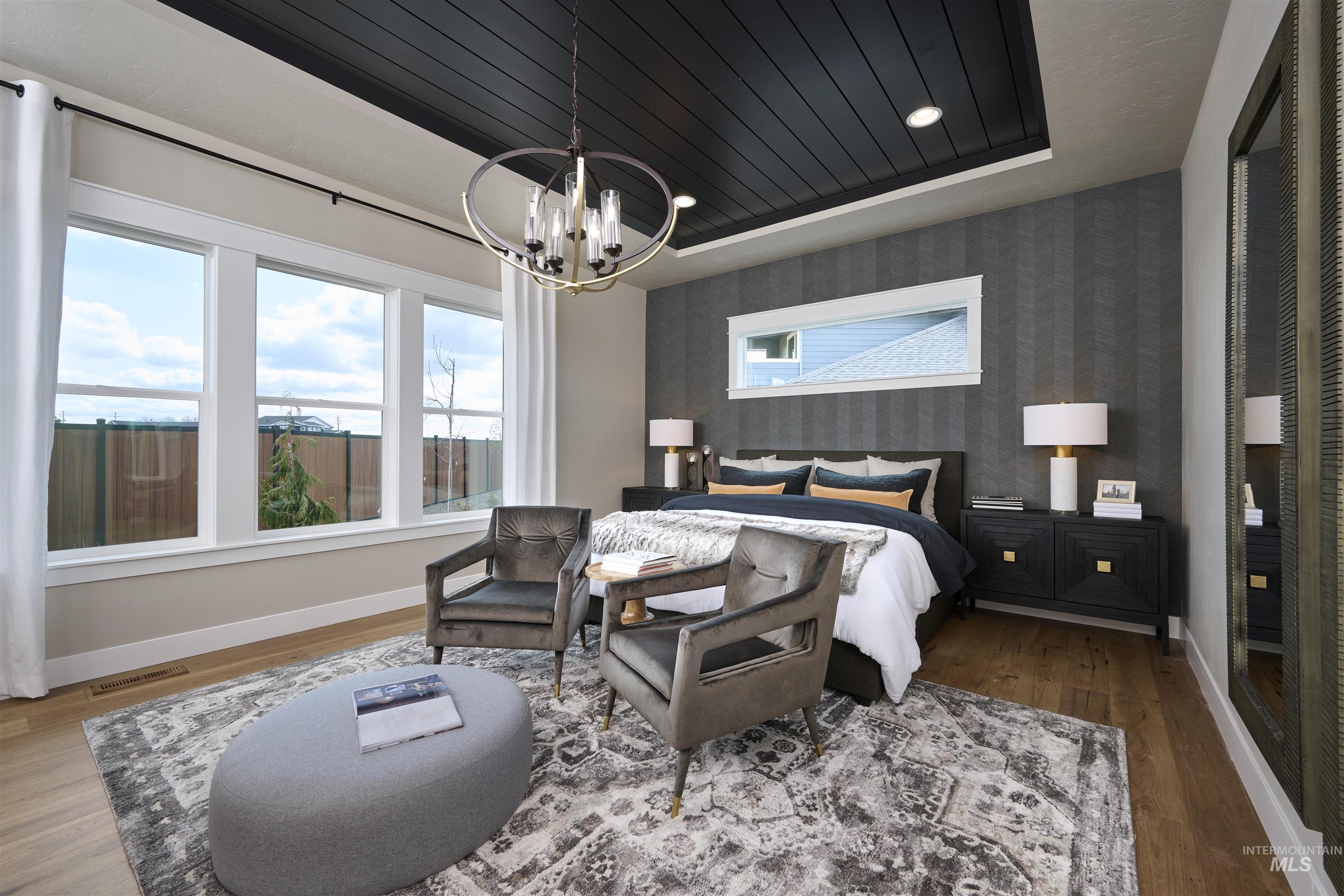 3370 North Del Sol Way Star, ID 83669 - Photo 11 of 30 Bedroom with wallpapered walls, wood finished floors, multiple windows, a wood tray ceiling, and suspended lighting