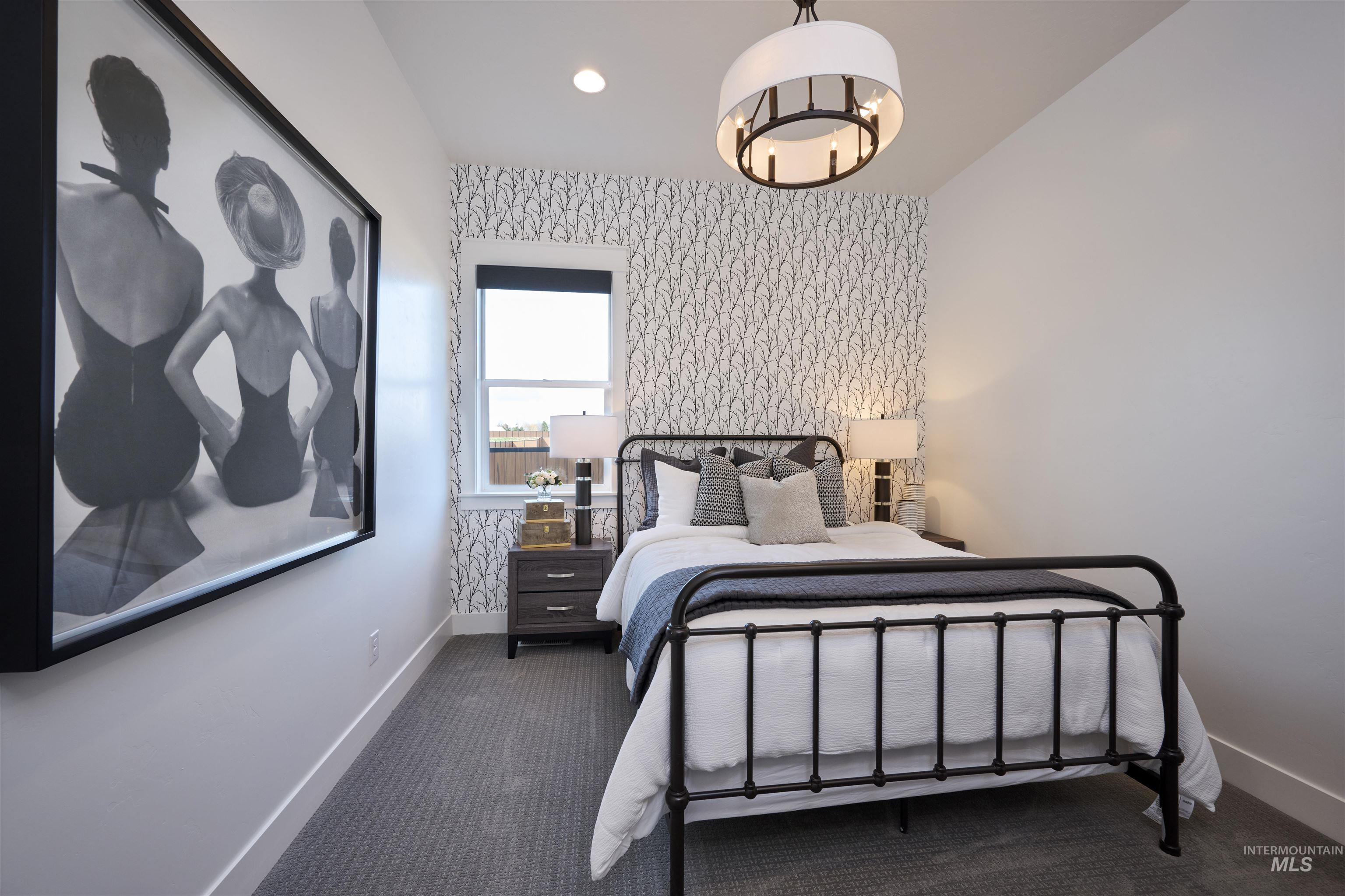 3370 North Del Sol Way Star, ID 83669 - Photo 15 of 30 Bedroom featuring dark colored carpet, wallpapered walls, an accent wall, and suspended lighting