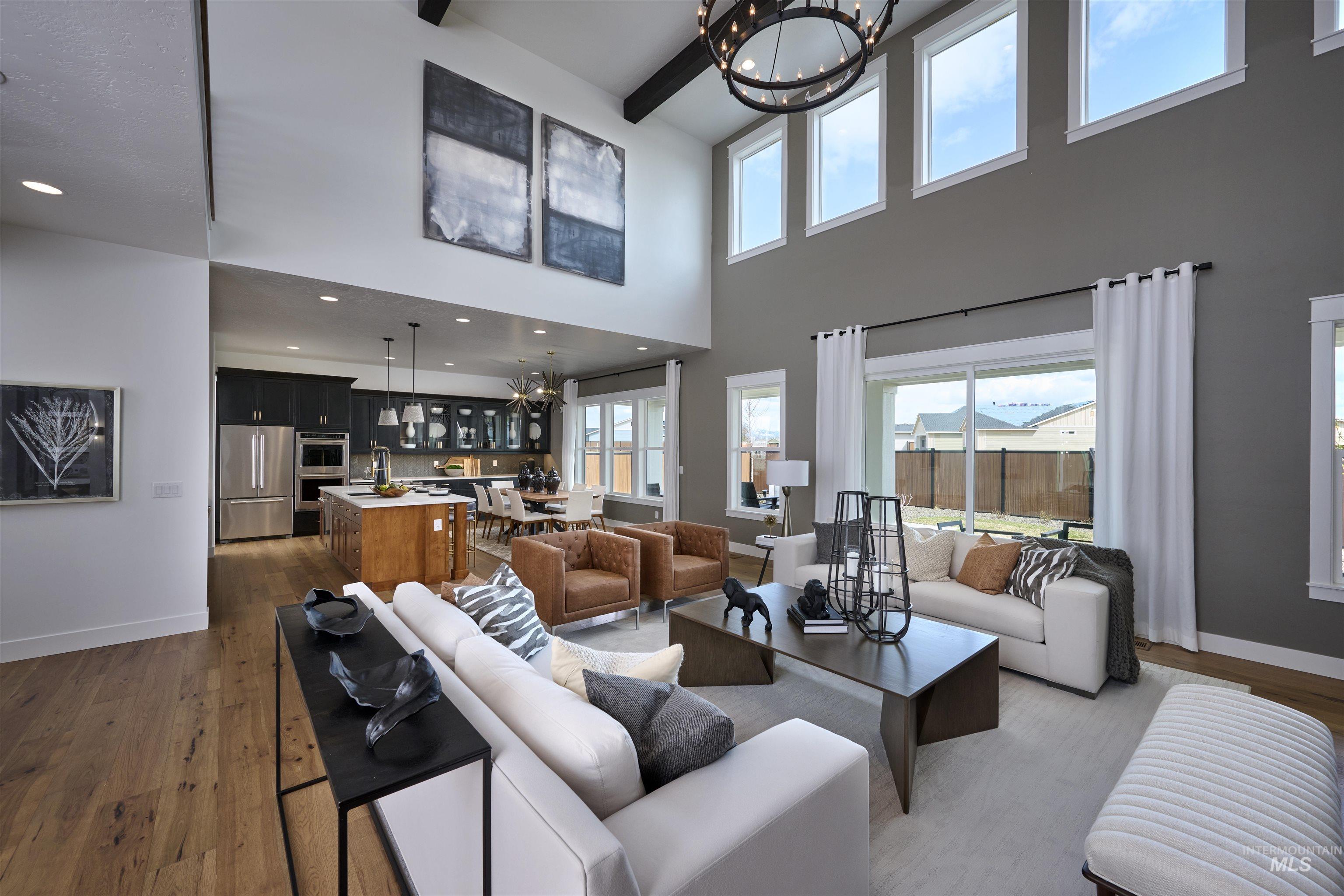 3370 North Del Sol Way Star, ID 83669 - Photo 2 of 30 Living area with a chandelier, dark wood-type flooring, beam ceiling, and plenty of natural light
