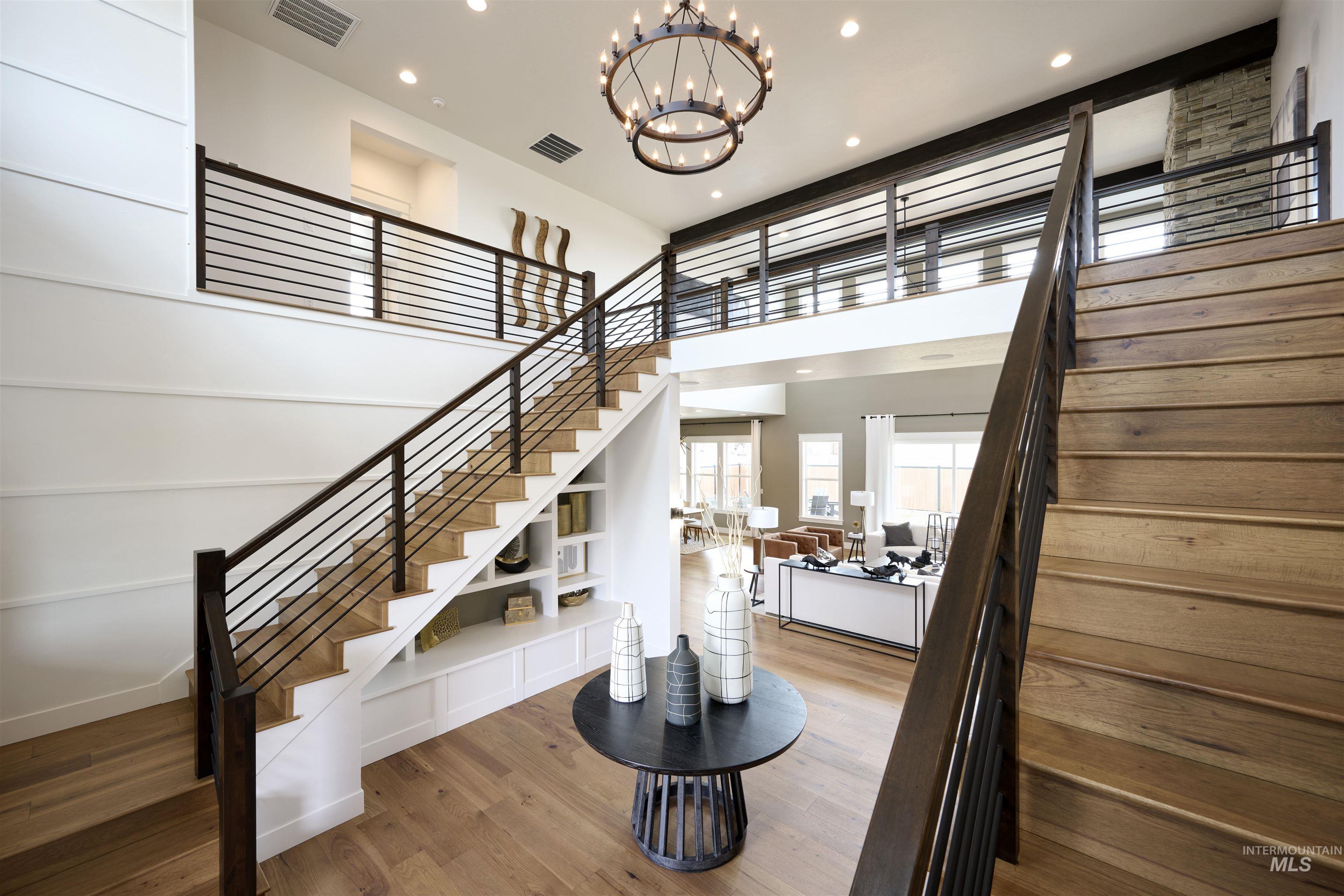 3370 North Del Sol Way Star, ID 83669 - Photo 20 of 30 Stairway featuring wood finished floors, a high ceiling, and a chandelier