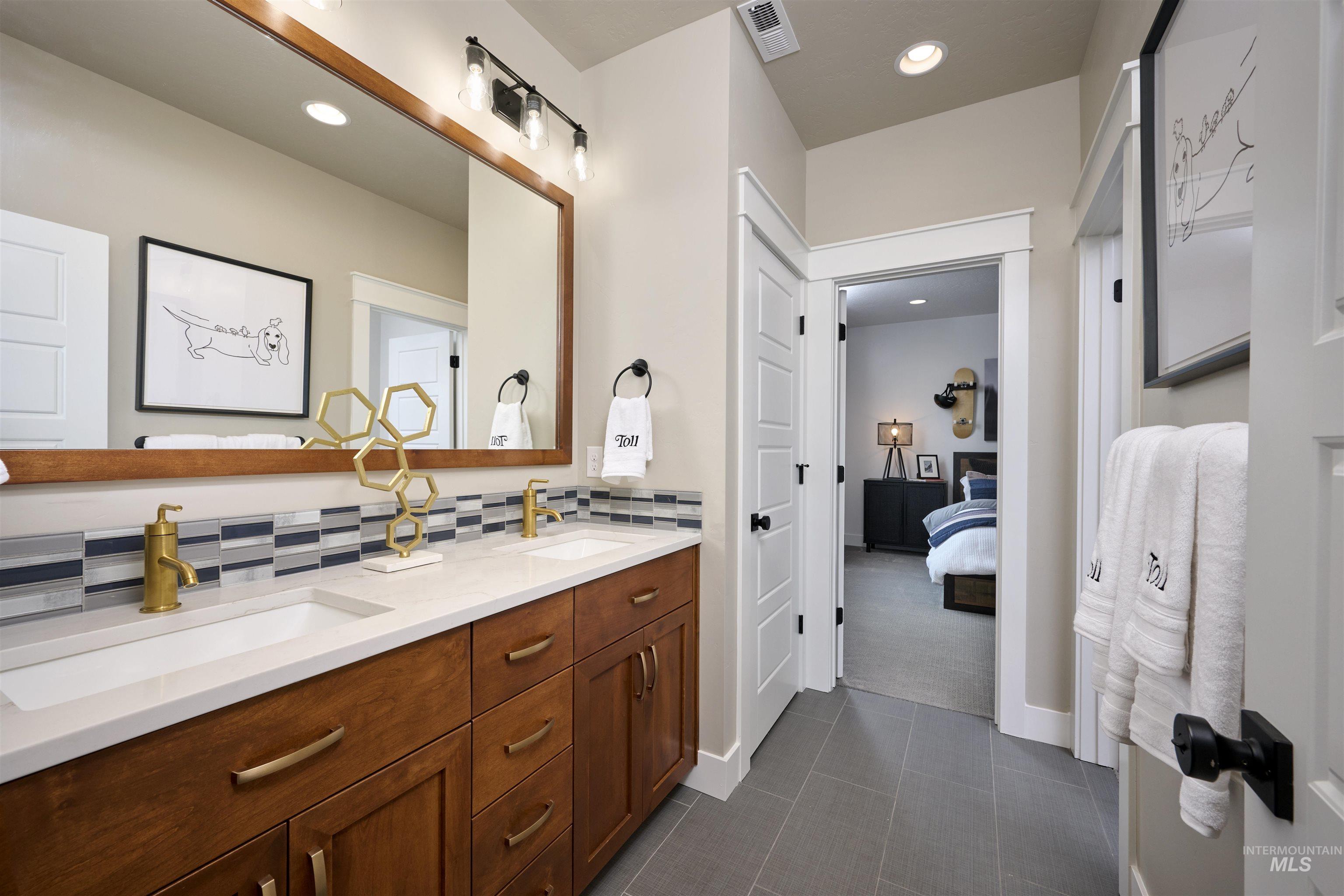 3370 North Del Sol Way Star, ID 83669 - Photo 27 of 30 Bathroom featuring double vanity, connected bathroom, recessed lighting, and tasteful backsplash