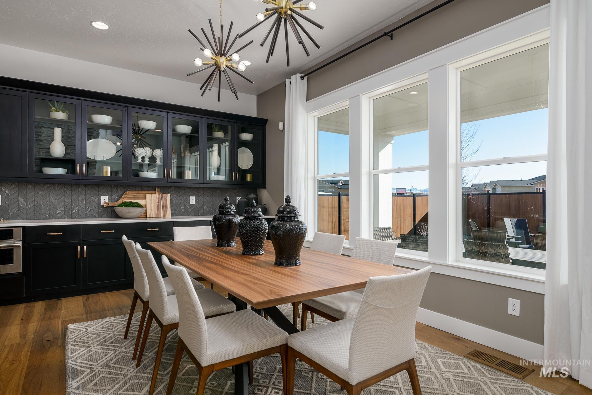 3370 North Del Sol Way Star, ID 83669 - Photo 9 of 30 Dining space featuring dark wood-style flooring and a chandelier