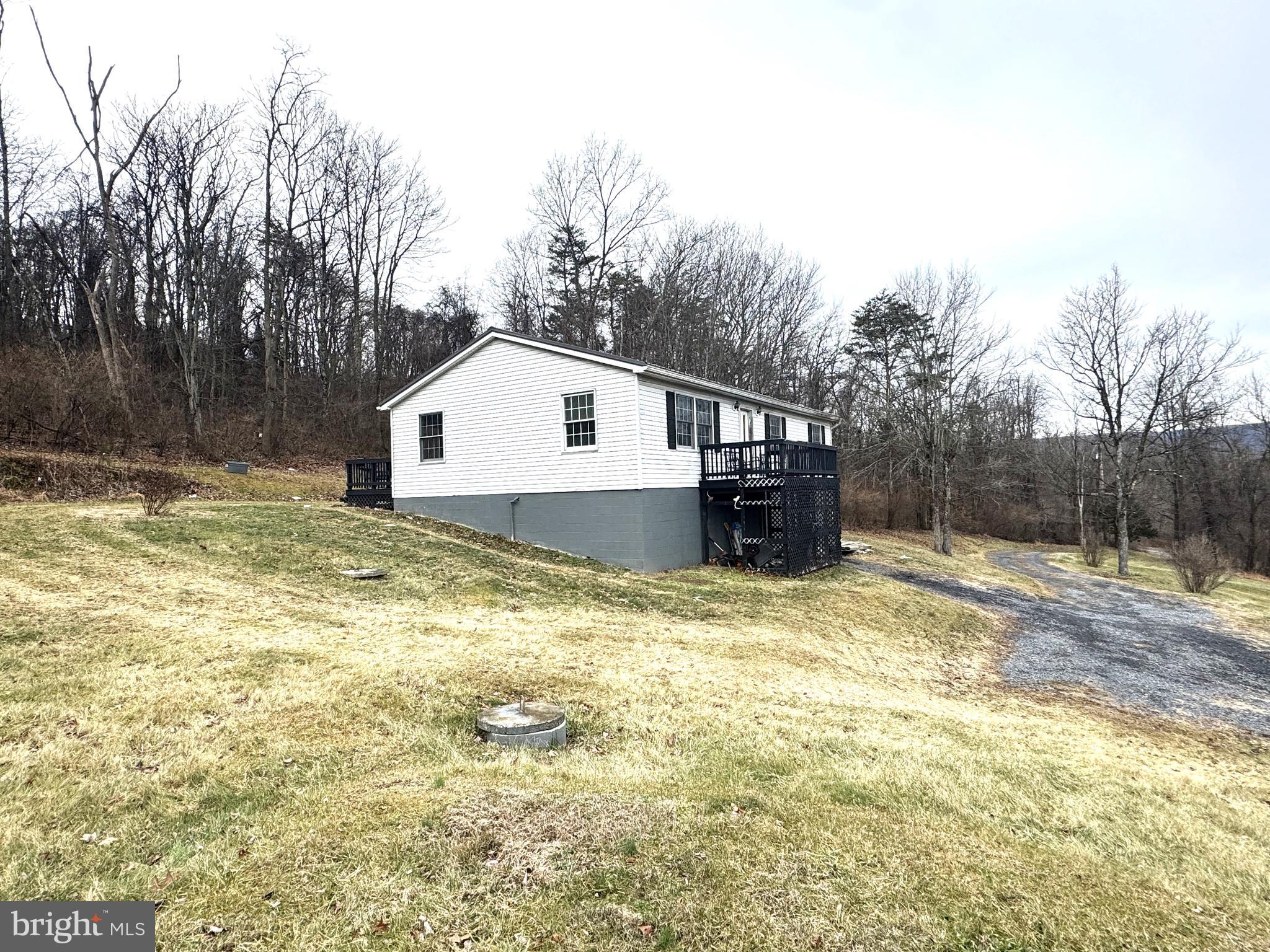 a view of a house with a yard and sitting area
