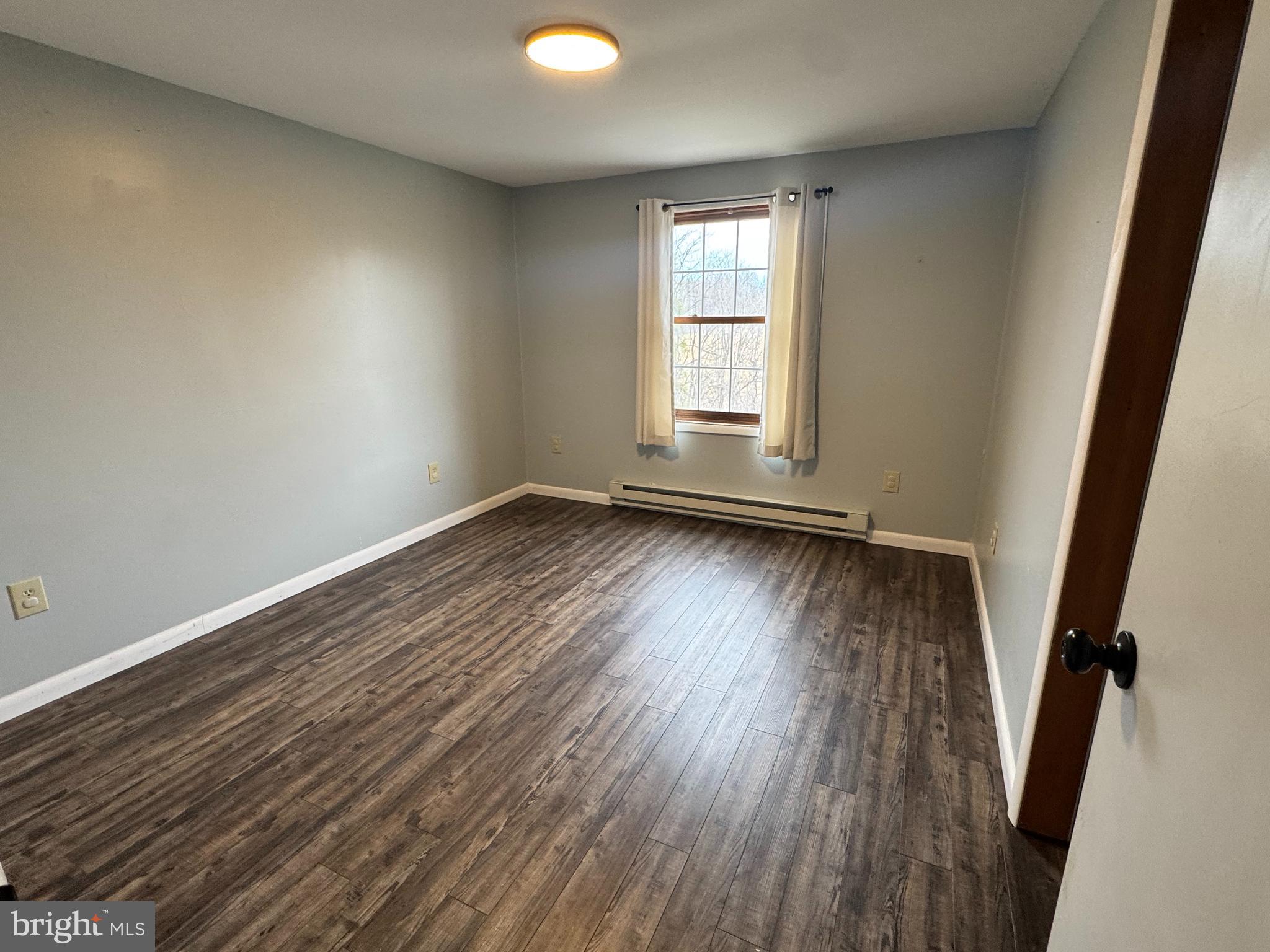 50 Irvin Road McVeytown, PA 17051 - Photo 11 of 19 an empty room with wooden floor and windows