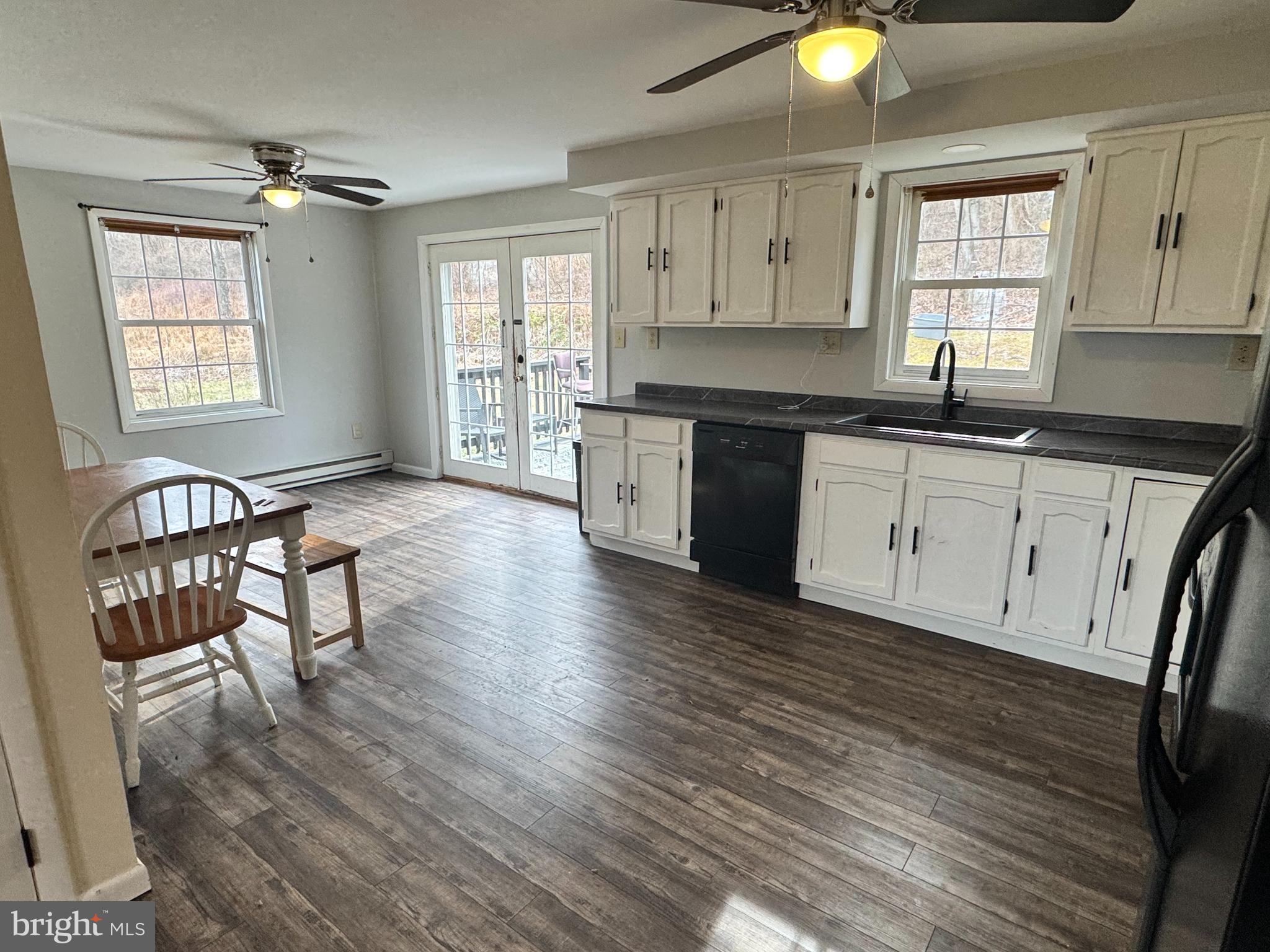 50 Irvin Road McVeytown, PA 17051 - Photo 2 of 19 a kitchen with granite countertop a stove a sink and white cabinets with wooden floor