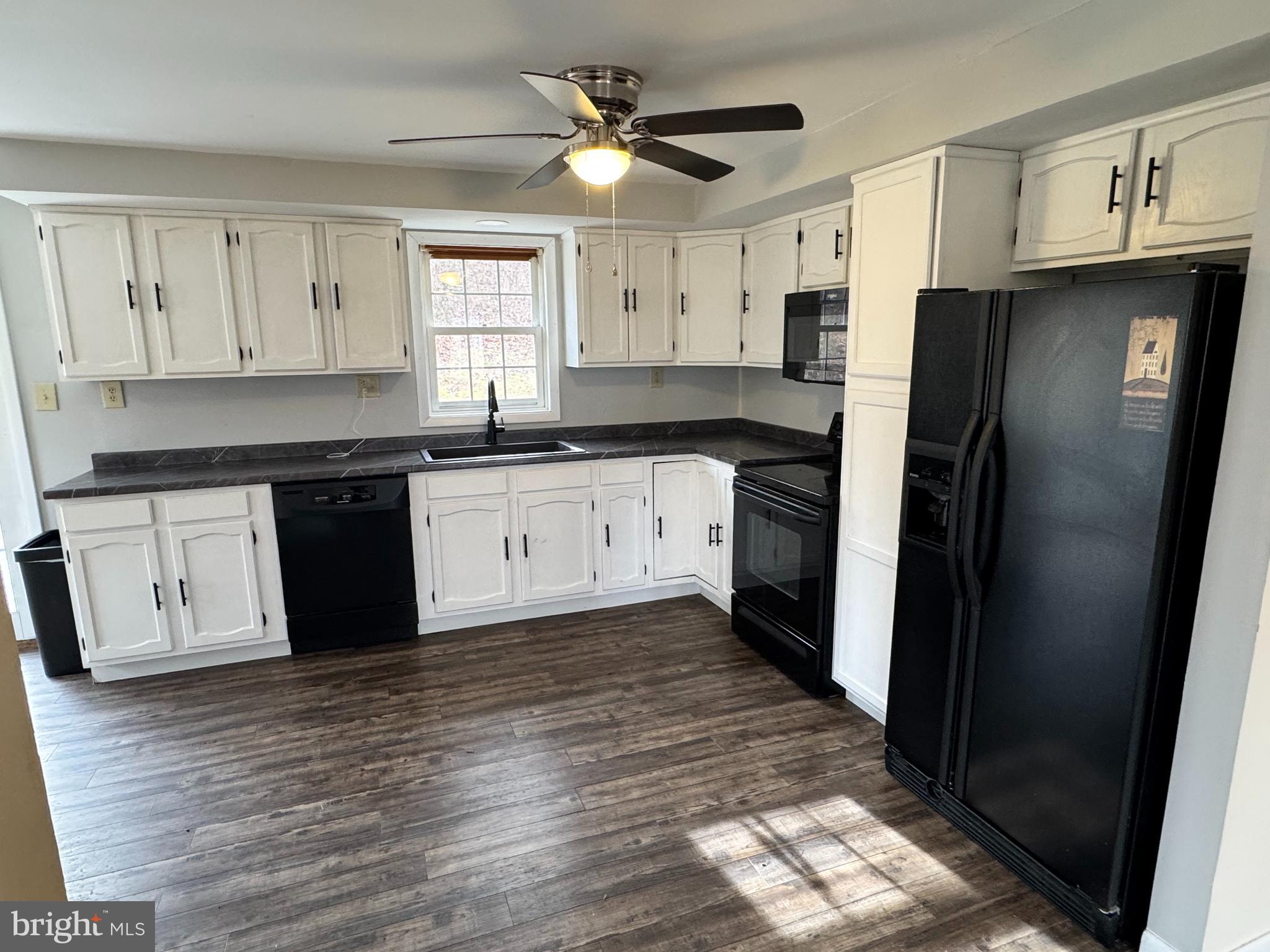 50 Irvin Road McVeytown, PA 17051 - Photo 3 of 19 a kitchen with granite countertop a refrigerator a sink and white cabinets