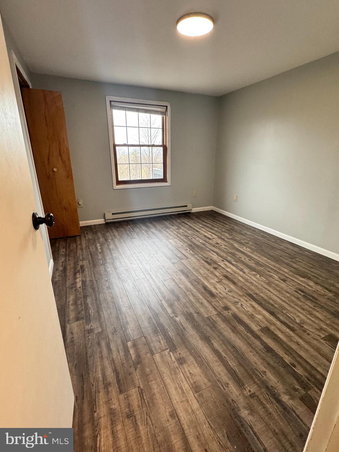 50 Irvin Road McVeytown, PA 17051 - Photo 9 of 19 an empty room with wooden floor and windows