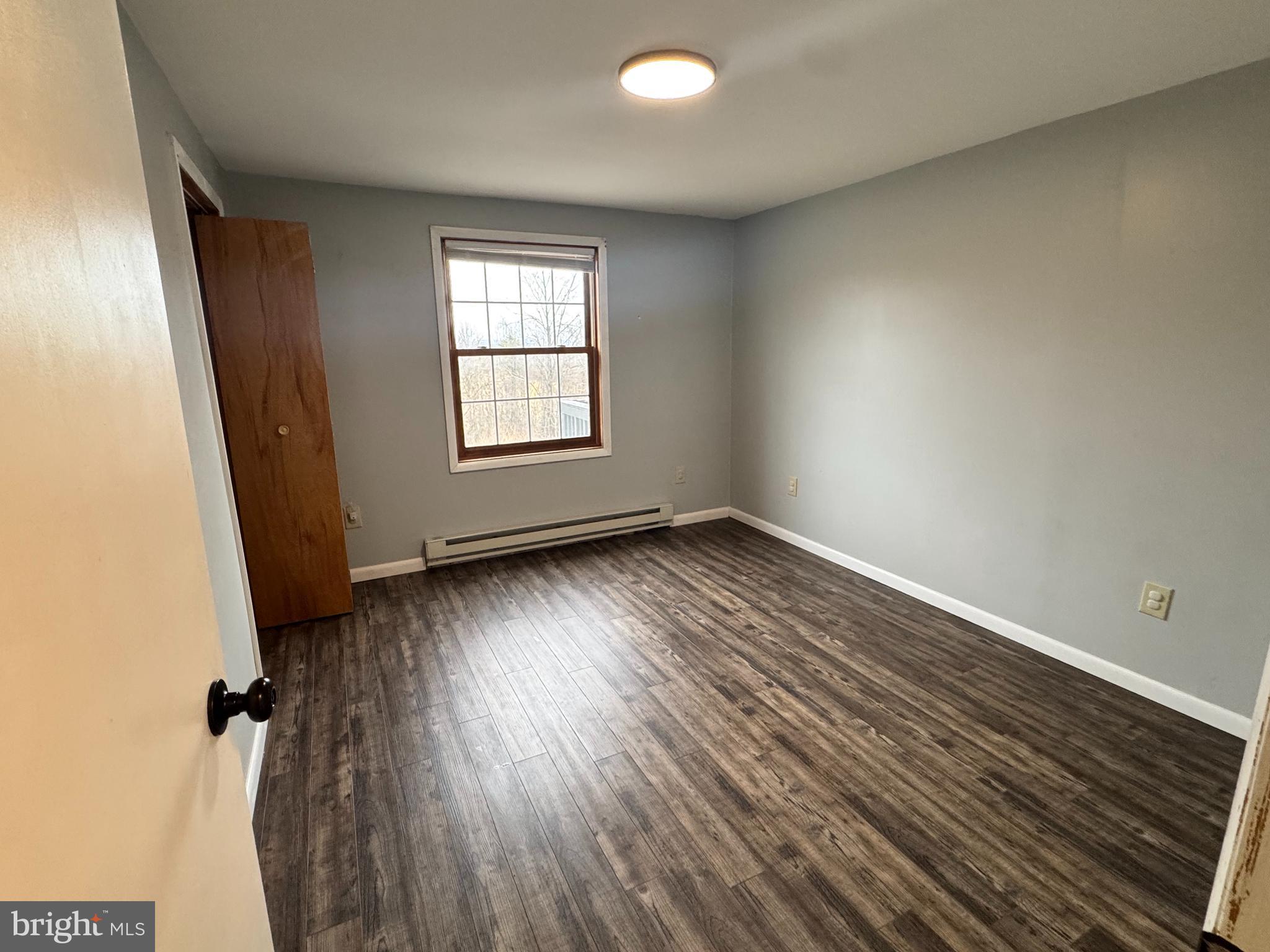 50 Irvin Road McVeytown, PA 17051 - Photo 10 of 19 an empty room with wooden floor and windows