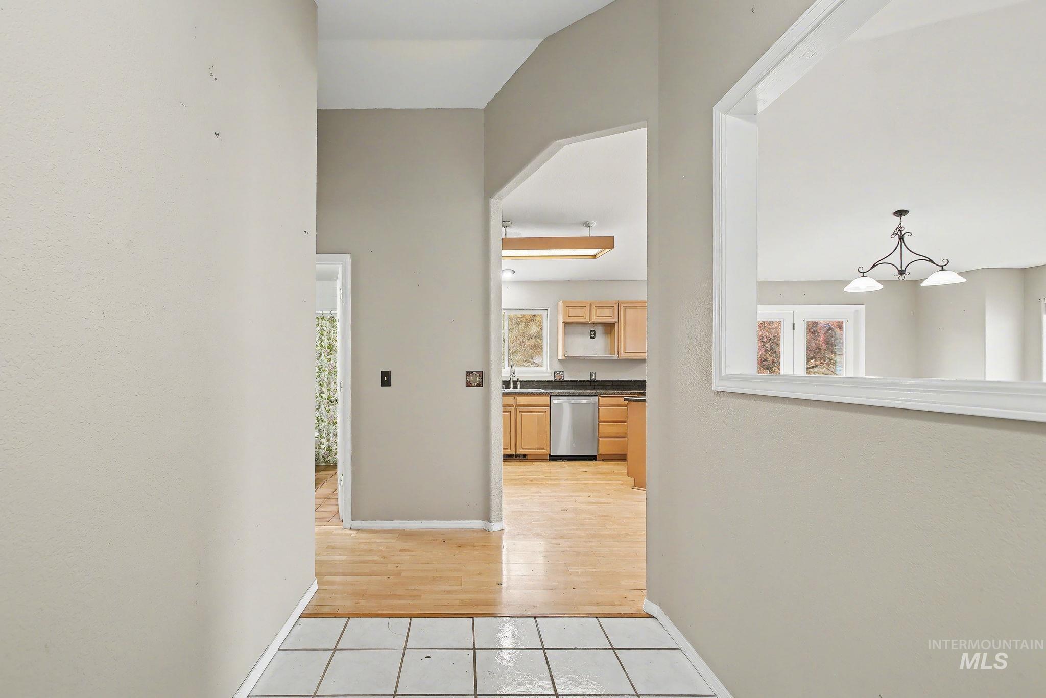 2242 Chukar Lane Clarkston, WA 99403 - Photo 6 of 41 Hall featuring light tile patterned floors and a chandelier