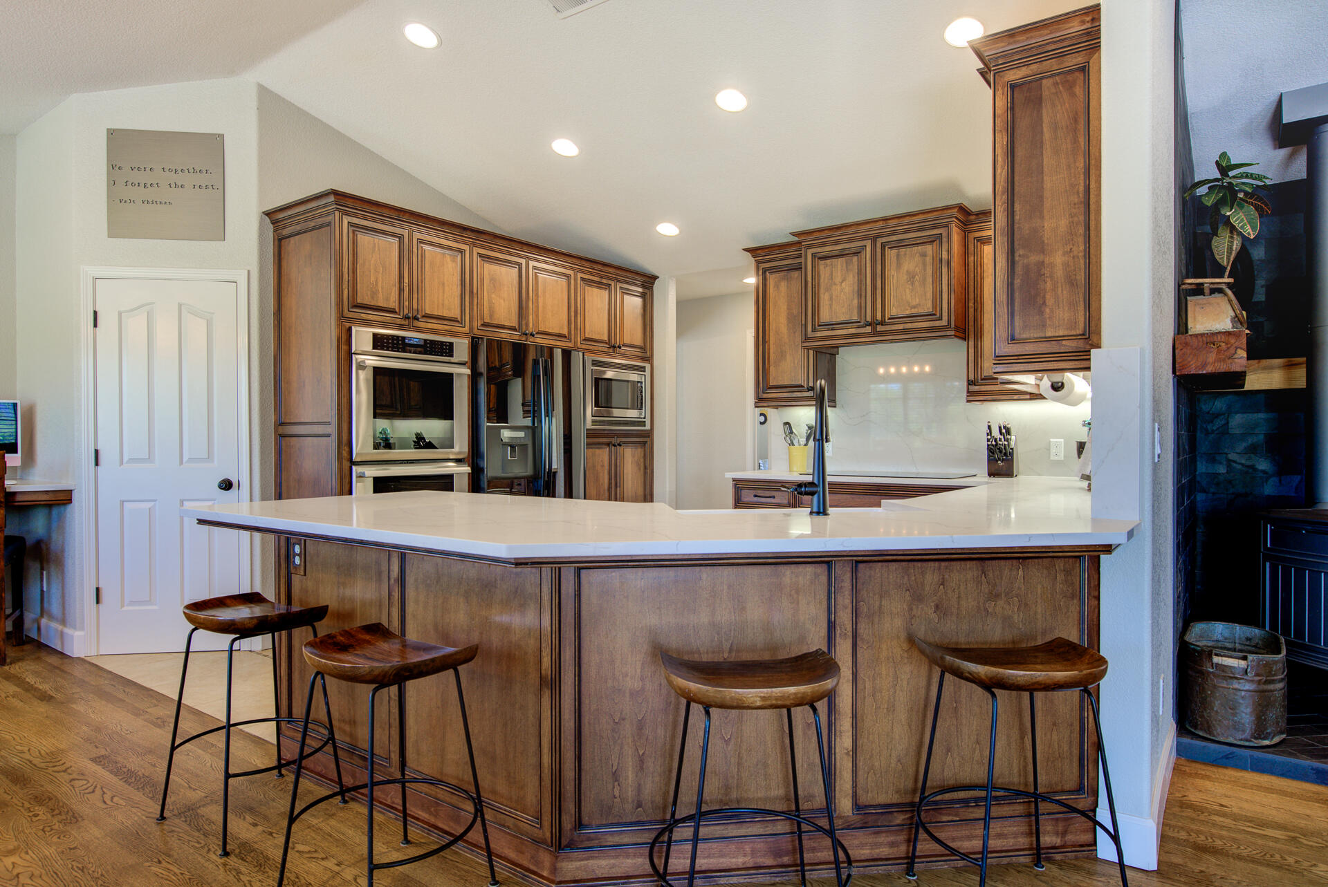 13416 Luna Drive Redding, CA 96003 - Photo 18 of 64 a kitchen with stainless steel appliances a dining table chairs and cabinets