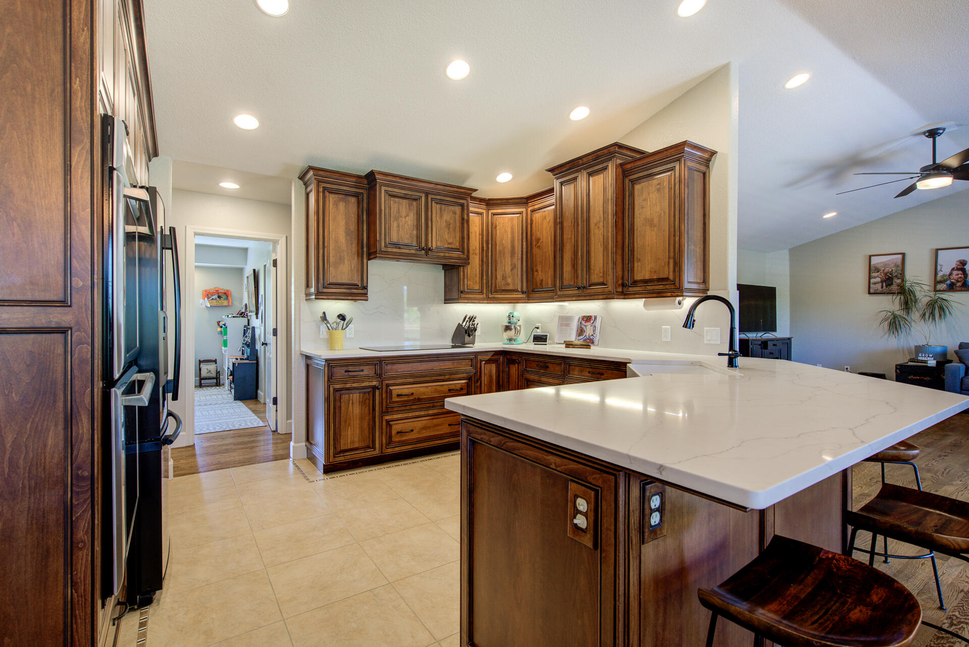 13416 Luna Drive Redding, CA 96003 - Photo 22 of 64 a kitchen with kitchen island a stove a sink a refrigerator and chairs