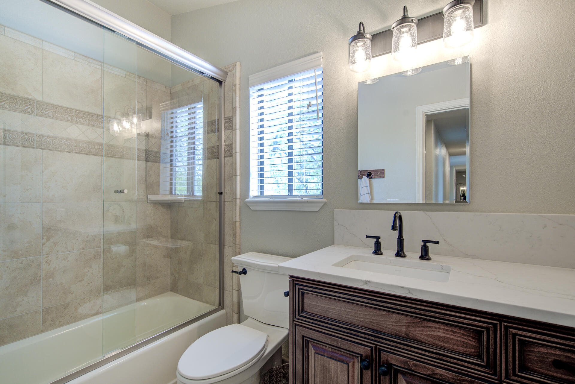 13416 Luna Drive Redding, CA 96003 - Photo 28 of 64 a bathroom with a sink toilet a mirror and shower