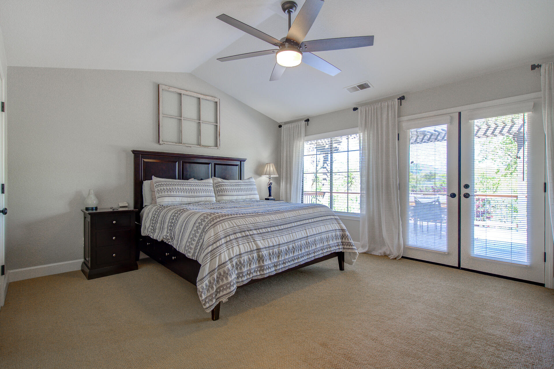13416 Luna Drive Redding, CA 96003 - Photo 31 of 64 a bedroom with a large bed and a ceiling fan