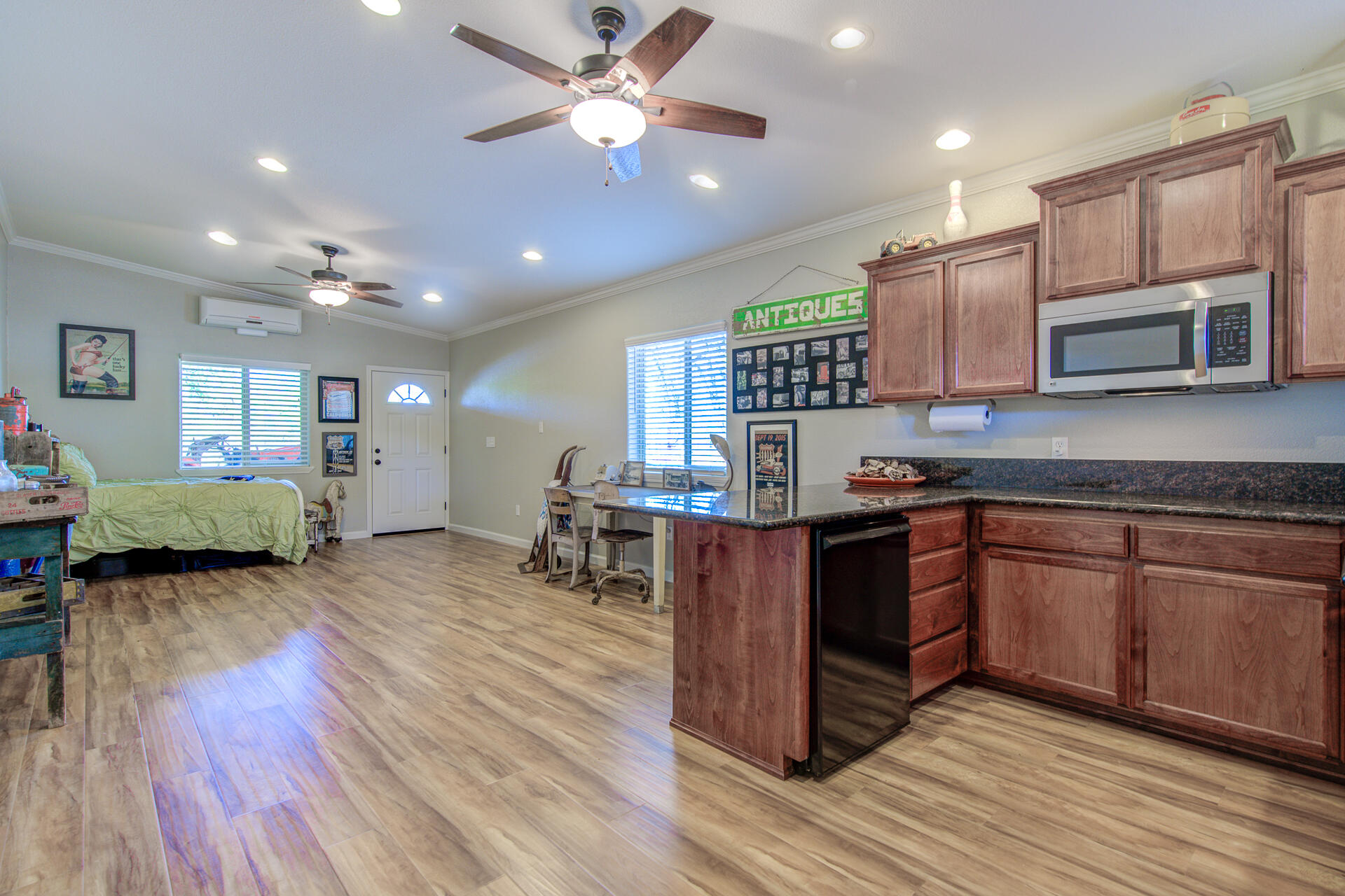 13416 Luna Drive Redding, CA 96003 - Photo 46 of 64 a kitchen with kitchen island granite countertop wooden floors and a view of living room