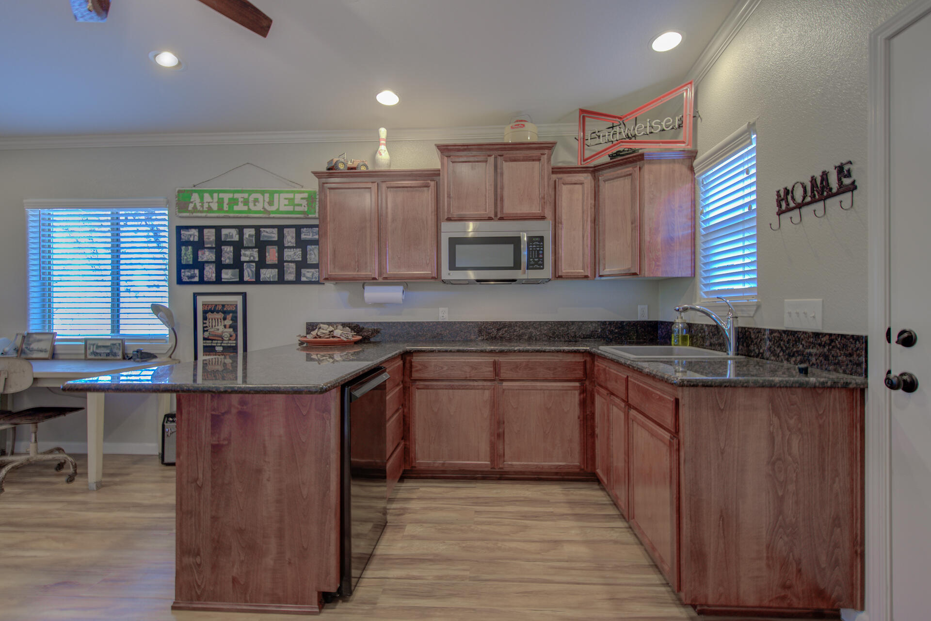 13416 Luna Drive Redding, CA 96003 - Photo 47 of 64 a kitchen with kitchen island granite countertop a sink window and cabinets