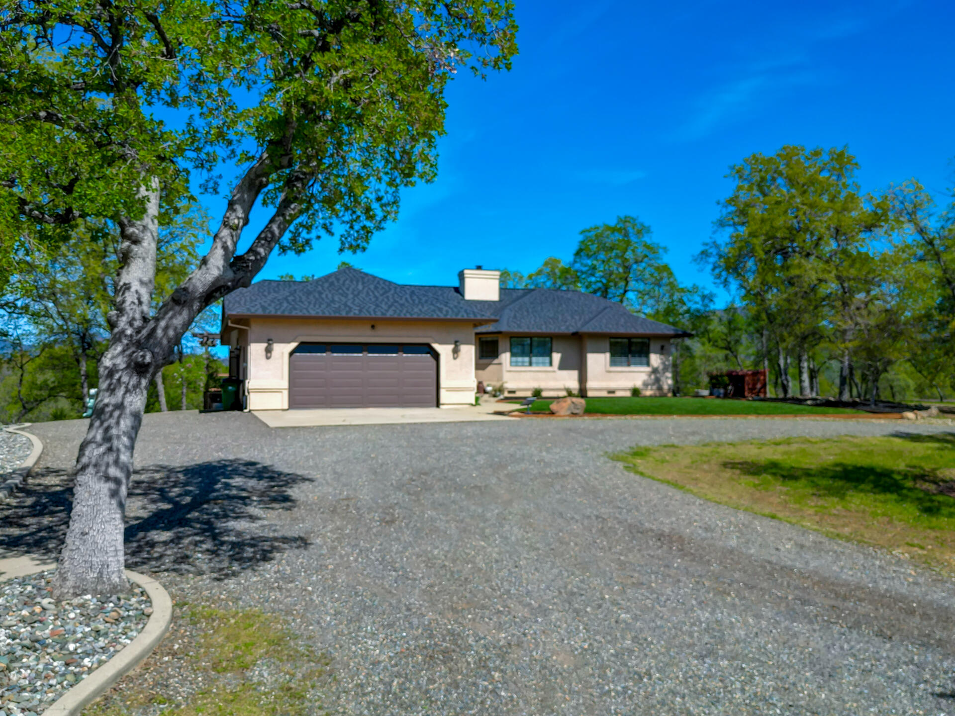 13416 Luna Drive Redding, CA 96003 - Photo 8 of 64 a front view of a house with a yard and garage