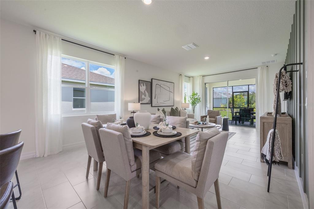 3973 Kennebunk Loop Mount Dora, FL 32757 - Photo 16 of 37 a view of a dining room with furniture and a window