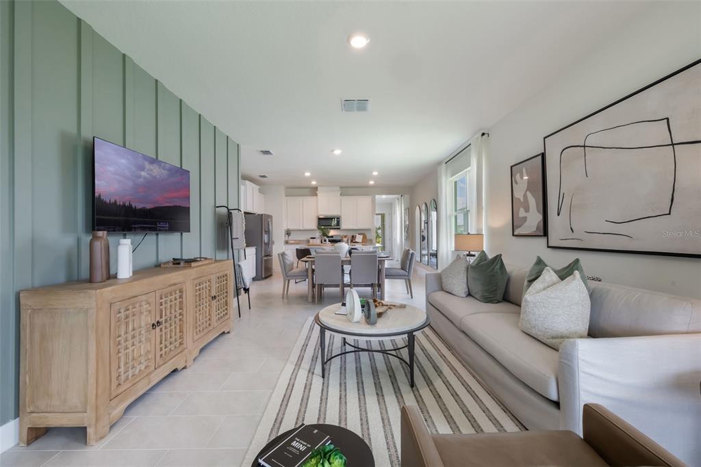 3973 Kennebunk Loop Mount Dora, FL 32757 - Photo 20 of 37 a living room with furniture and a flat screen tv