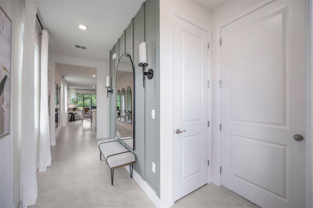 3973 Kennebunk Loop Mount Dora, FL 32757 - Photo 4 of 37 a view of a hallway with wooden floor and a bathroom