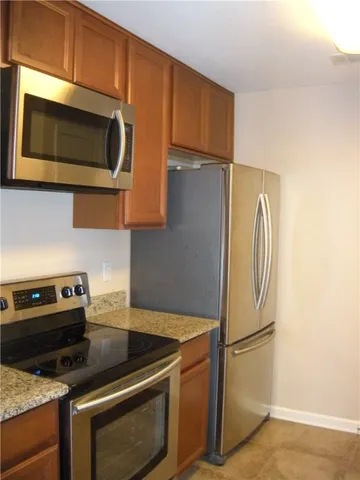 a kitchen with a stove microwave and refrigerator