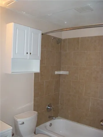 a bathroom with a shower a toilet and sink