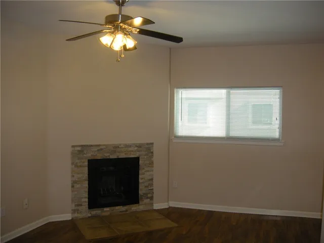 a room with a fireplace and a chandelier fan