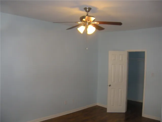 a view of a chandelier fan and hardwood floor