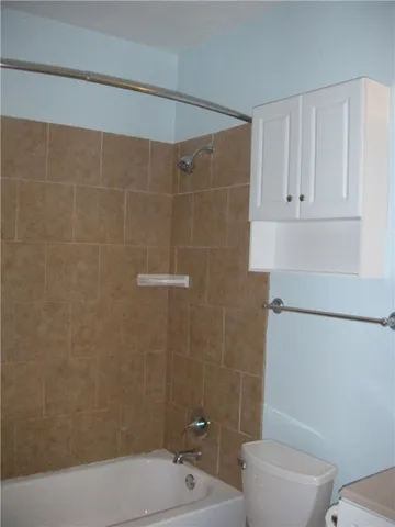 a bathroom with a toilet and shower