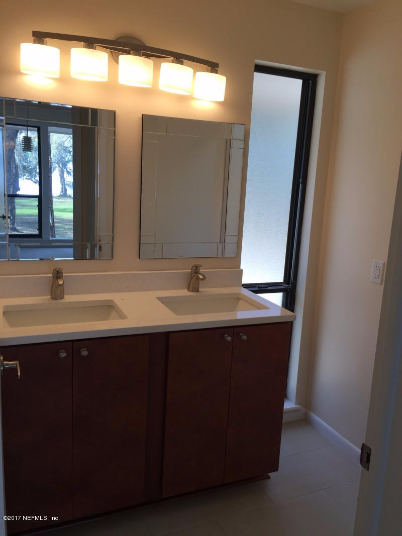 4127 Magnolia Road Orange Park, FL 32065 - Photo 13 of 24 a bathroom with a sink and a mirror