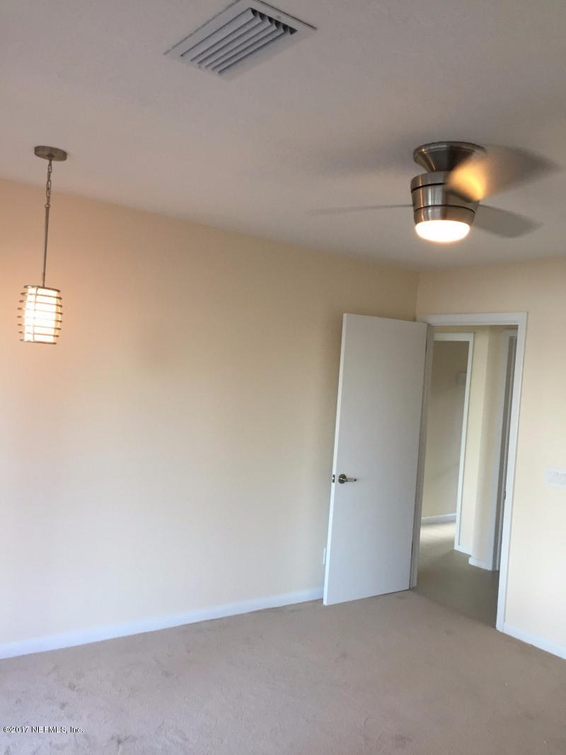 4127 Magnolia Road Orange Park, FL 32065 - Photo 17 of 24 an empty room with a mirror and vanity