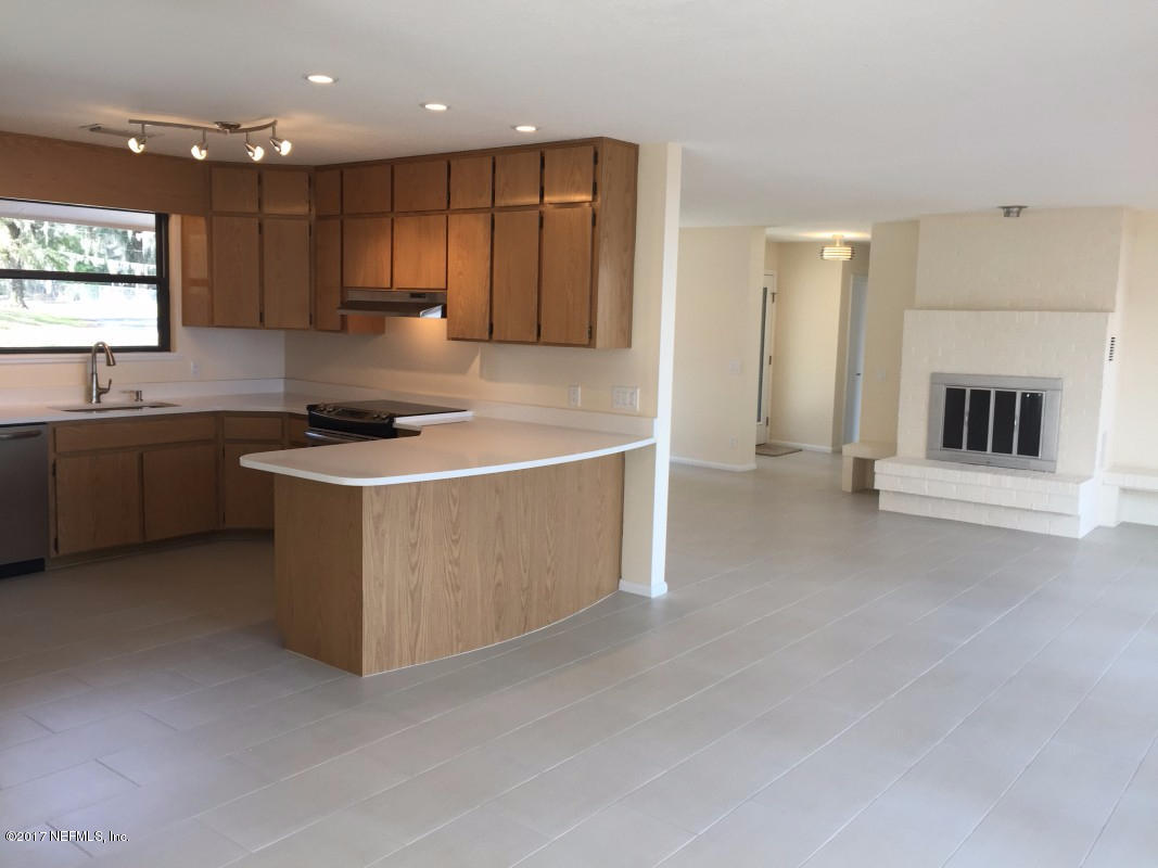 4127 Magnolia Road Orange Park, FL 32065 - Photo 5 of 24 a kitchen with stainless steel appliances granite countertop a stove a sink and a refrigerator