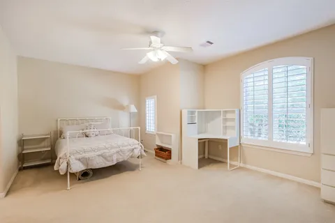 a bedroom with a bed and a chair