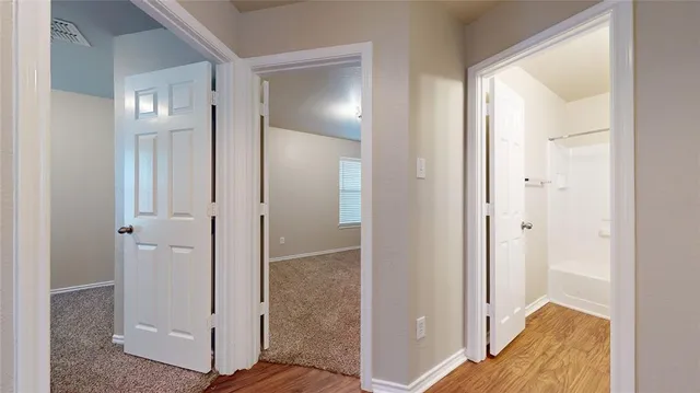 a view of an empty room and a window