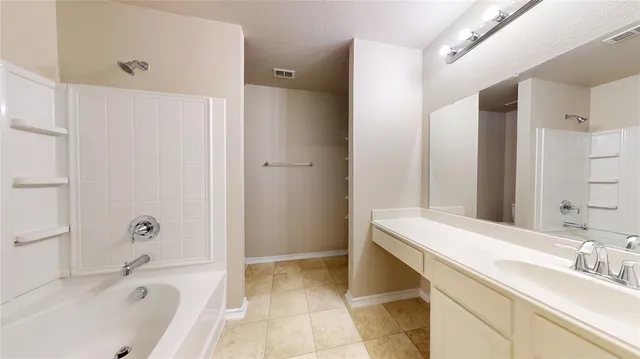 a bathroom with a tub and sink
