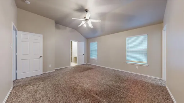 a view of hallway with stairs and a window