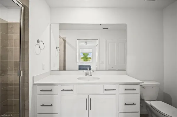 a bathroom with a sink vanity and a mirror
