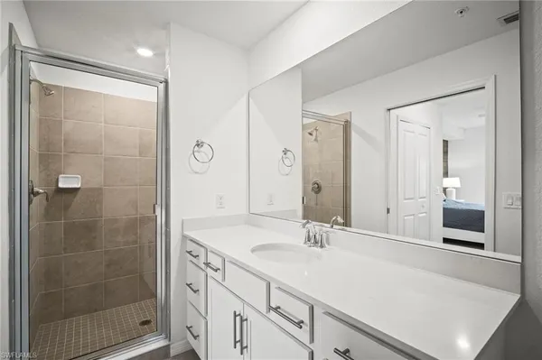 a bathroom with a shower sink and mirror