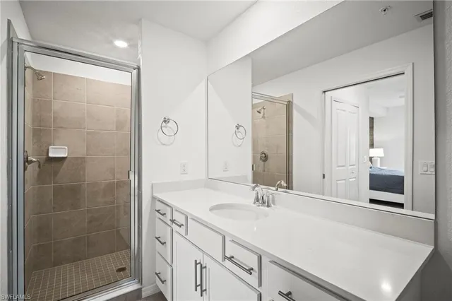 a bathroom with a shower sink and mirror