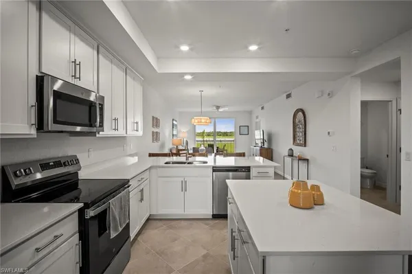 a kitchen with a sink a stove and cabinets