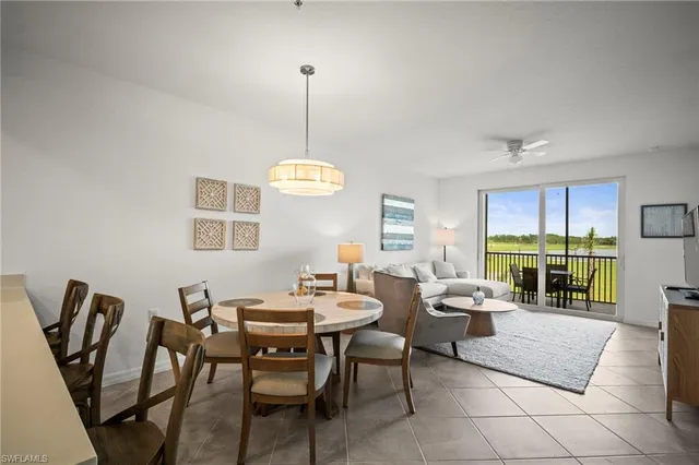a dining room with furniture a chandelier and wooden floor