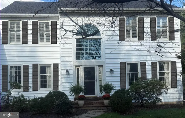 a view of a house with brick walls and flower plants