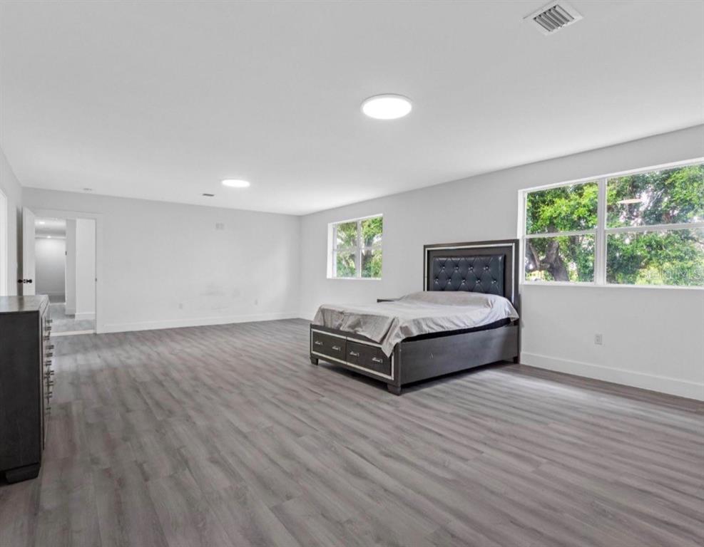 2440 Wallace Road Bartow, FL 33830 - Photo 18 of 27 a spacious bedroom with a bed and wooden floor