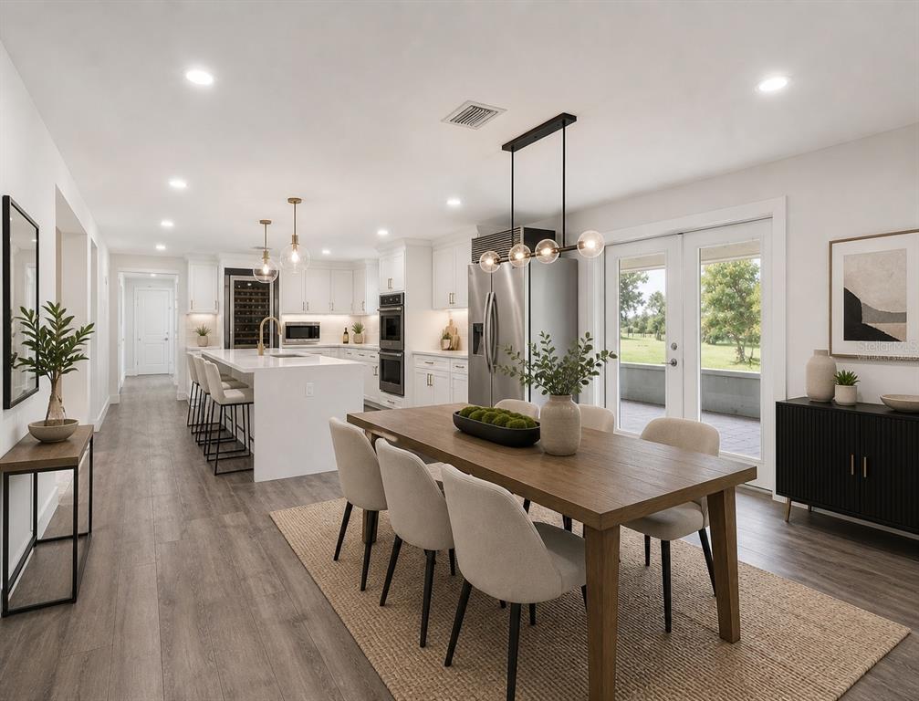 2440 Wallace Road Bartow, FL 33830 - Photo 10 of 27 a kitchen with a dining table chairs stainless steel appliances and cabinets
